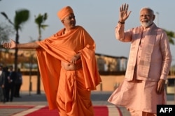 India's Prime Minister Narendra Modi waves during a tour of the BAPS Hindu Mandir, the largest Hindu temple in the Middle East, at its inauguration ceremony on Feb. 14, 2024, in Abu Dhabi.