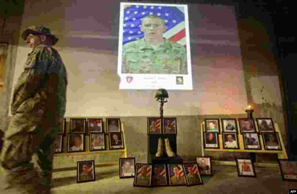 An image of Pfc. Joshua Jetton is projected above as Lt. Col. Daniel Wilson, 47, of San Diego, Calif., commander of the U.S. Army's 2nd Battalion 27th Infantry Regiment of the 25th Infantry Division, 3rd Brigade Combat Team based in Schofield Barracks, Ha