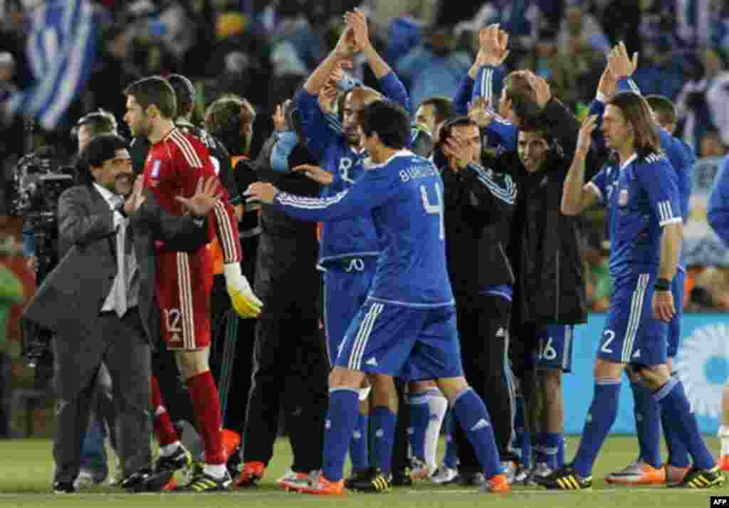 Argentina head coach Diego Maradona, left, celebrates with this team after the World Cup group B soccer match between Greece and Argentina at Peter Mokaba Stadium in Polokwane, South Africa, Tuesday, June 22, 2010. Argentina won 2-0. (AP Photo/Eugene Hosh