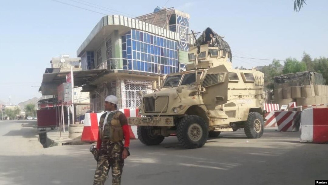 FILE - An Afghan security force personnel stands guard at the entrance gate of the government compound of Farah province, western Afghanistan, May 15, 2018. 