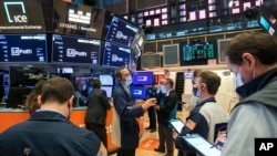 In this photo provided by the New York Stock Exchange, traders work on the floor, Apr. 21, 2021. (Courtney Crow/New York Stock Exchange via AP)