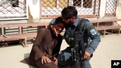 FILE - A man cries after an attack in maternity hospital, in Kabul, Afghanistan, May 12, 2020.