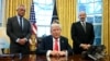 US President Donald Trump speaks to the press before signing an Executive Order, alongside US Secretary of Health and Human Services Robert F. Kennedy Jr. (L) and US Secretary of Commerce nominee Howard Lutnick (R), at the Oval Office of the White House i