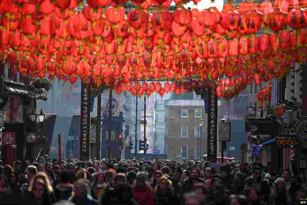 Crowds watch the celebrations for the Chinese Lunar New Year in London&#39;s China town in central London.
