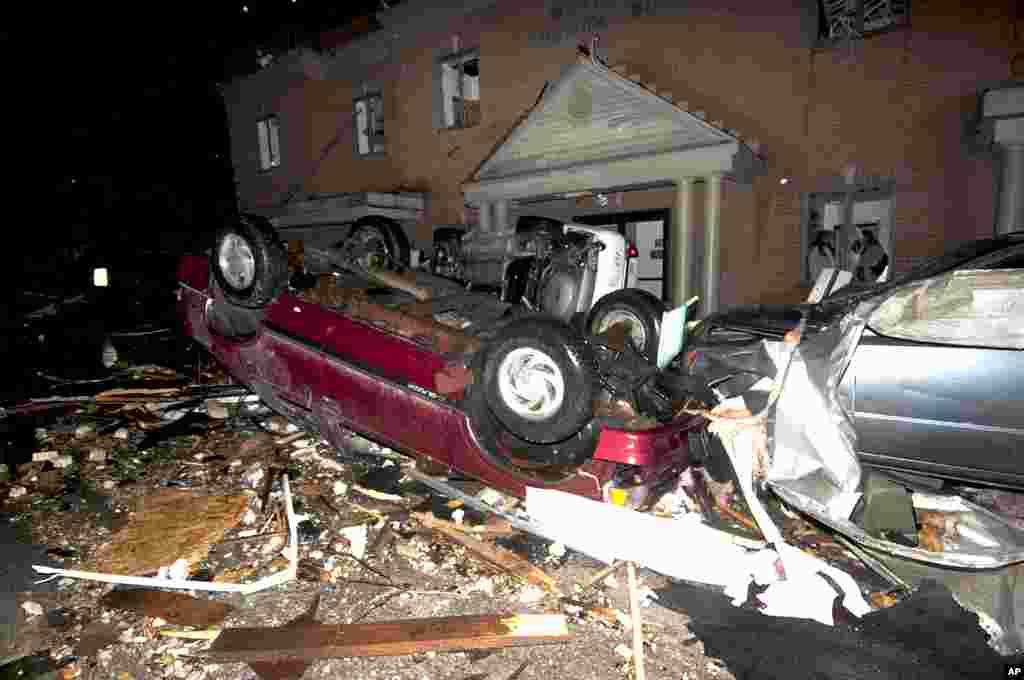 Vehicles, including two police cruisers, are piled up in front of the West Liberty City Hall following a tornado strike, in West Liberty, Kentucky. It was the second tornado to hit the town in a week. (APl)