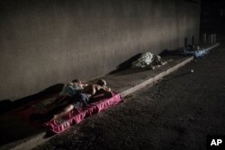 FILE - People sleep outside their homes during a blackout in the sweltering city of Maracaibo, Venezuela, May 15, 2019.