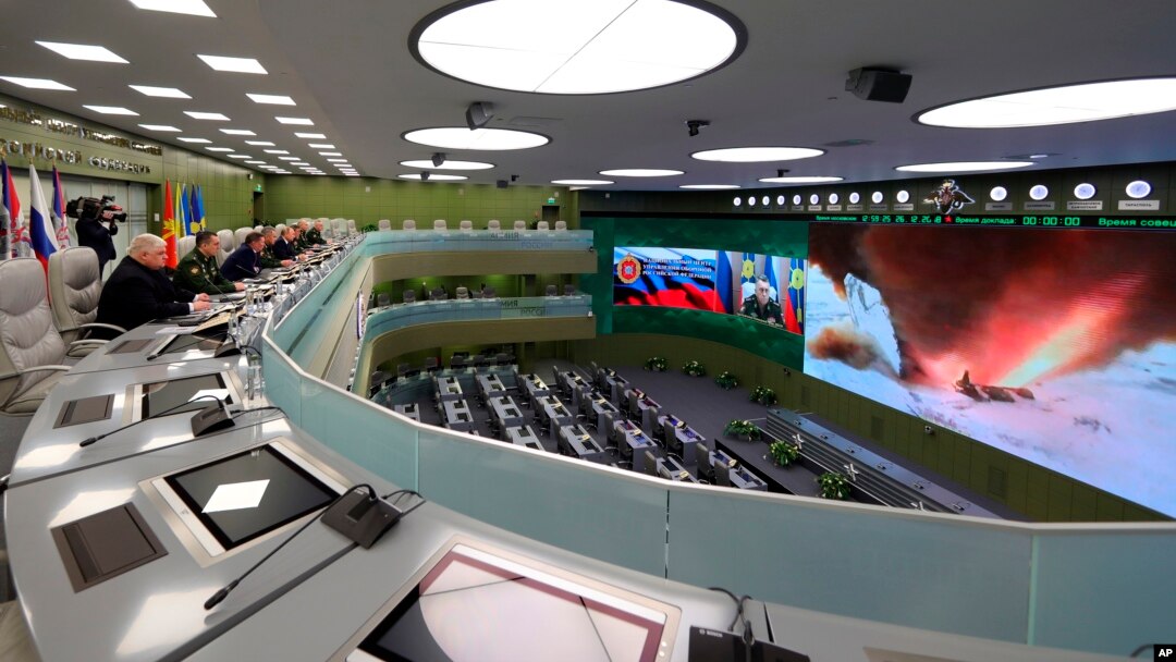 Russian President Vladimir Putin, fifth left, and other top officials oversee the test launch of the Avangard hypersonic missile from the Defense Ministry's control room in Moscow, Dec. 26, 2018. 