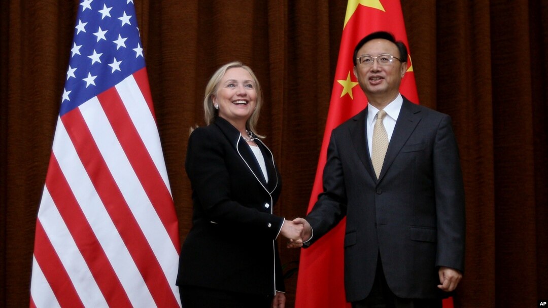U.S. Secretary of State Hillary Rodham Clinton, left, and Chinese Foreign Minister Yang Jiechi, right, shake hands during her visit to Beijing, Sept. 4, 2012. 