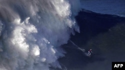 Brazilian surfer Maya Gabeira rides a wave off Praia do Norte in Nazare, Portugal, Jan. 18, 2018.