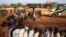 FILE - Passengers hoping to travel to Nairobi line up at a bus in the town of Mandera near the Kenya-Somalia border, Dec. 8, 2014.