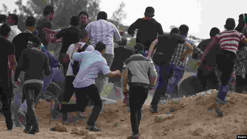 Supporters of the Muslim Brotherhood and ousted Egyptian President Mohamed Morsi chase after journalists, who they claim to be pro-army, Nov. 4, 2013.