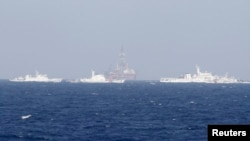 FILE - Chinese oil rig Haiyang Shi You 981 is seen surrounded by ships of China Coast Guard in the South China Sea, about 210 km (130 miles) off shore of Vietnam.
