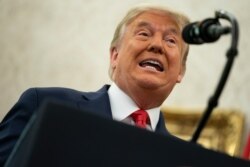 Donald Trump speaks during a ceremony in the Oval Office of the White House, Dec. 3, 2020, in Washington.