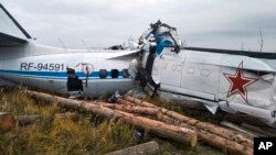 This photo provided by the Russian Emergency Situations Ministry press service shows the L-410, a Czech-made twin-engine turboprop, crashed near the town of Menzelinsk, about 960 kilometers (600 miles) east of Moscow, Russia, Oct. 10, 2021.