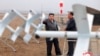 This picture taken on Nov. 14, 2024, and released from North Korea's official Korean Central News Agency via KNS on Nov. 15, 2024 shows North Korean leader Kim Jong Un, left, inspecting the performance test of drones at an undisclosed location. 