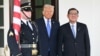 U.S. President Donald Trump greets Japanese Prime Minister Shigeru Ishiba upon arrival outside the White House in Washington on Feb. 7, 2025. 