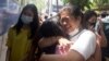 Protesters detained by police during the anti-coup demonstrations react after being released at Tamwe township police station in Yangon, Myanmar.