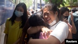 Protesters detained by police during anti-overthrow demonstrations react after being released at Tamwe township police station in Yangon, Myanmar.