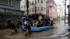 Security force members use an inflatable raft to bring residents to safety from a flooded area near the bank of the overflowing Bagmati River following heavy rains in Kathmandu, Nepal, on Sept. 28, 2024. 