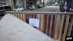 FILE - This photograph taken on October 3, 2023 shows a placard reading "Bed bugs" on a mattress abandoned on the pavement in a street in Marseille, southern France.