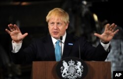 FILE - Britain's Prime Minister Boris Johnson gestures during a speech on domestic priorities in Manchester, Britain, July 27, 2019.