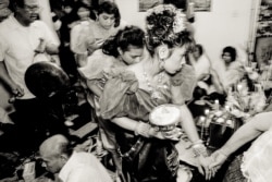 At an apartment in a public housing building on Chicago's north side, it's joy and trepidation at a traditional Cambodian wedding ceremony in the early 1990s. (Stuart Isett)