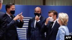 Left to right, Dutch Prime Minister Mark Rutte, European Council President Charles Michel, French President Emmanuel Macron and President of the European Commission Ursula von der Leyen chat at a European Union summit in Brussels, Belgium, July 21, 2020.