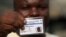 Muritala Diekola, display his new voters registration card in Lagos, Nigeria, Saturday, Jan. 15, 2011. An effort to register 70 million voters across Nigeria before its April presidential election wobbled to a start Saturday, as volunteers fought with mal