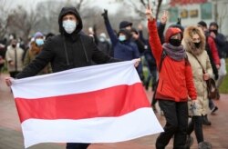 FILE - Belarusian opposition supporters attend a rally to reject the presidential election results in Minsk, Belarus, Nov. 22, 2020.