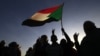 FILE - Demonstrators wave a flag in Khartoum, Sudan, Nov. 25, 2019.