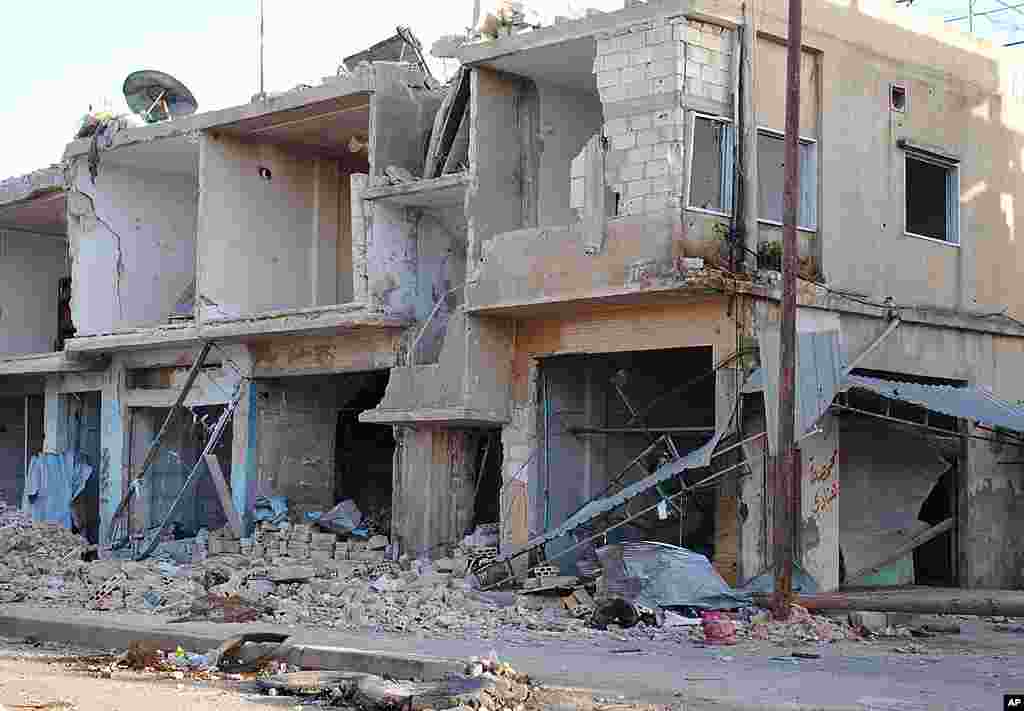 Shops and homes are seen after they were destroyed by Syrian government shelling in Rastan, Homs province, March 20, 2012. (AP)