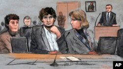 FILE - In this courtroom sketch, Dzhokhar Tsarnaev, center, is depicted between defense attorneys Miriam Conrad, left, and Judy Clarke, right, during his federal death penalty trial.