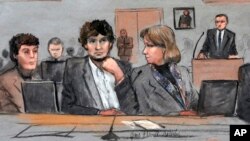 FILE - In this courtroom sketch, Dzhokhar Tsarnaev, center, is depicted between defense attorneys Miriam Conrad, left, and Judy Clarke, right, during his federal death penalty trial.