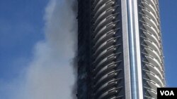 A view of the Address Hotel the morning after the fire, Jan. 1, 2016. (M. Besheer/VOA)