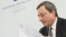 President of the European Central Bank (ECB) Mario Draghi looks at his notes during a press conference after the ECB Governing Council Meeting in Brdo, 60 km northeast of Ljubjana, October 4, 2012.