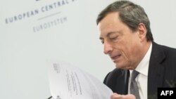 President of the European Central Bank (ECB) Mario Draghi looks at his notes during a press conference after the ECB Governing Council Meeting in Brdo, 60 km northeast of Ljubjana, October 4, 2012.