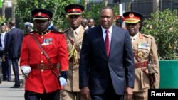 Kenya's President Uhuru Kenyatta walks to inspect an honor guard before the opening of the 12th Parliament outside the National Assembly Chamber in Nairobi, Kenya, Sept. 12, 2017.