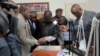 Tanzanian Minister for Finance and Planning Philip Mpango, center, and other government officials look at diamonds seized at the airport in Dar es Salaam, Tanzania, Sept. 9, 2017.