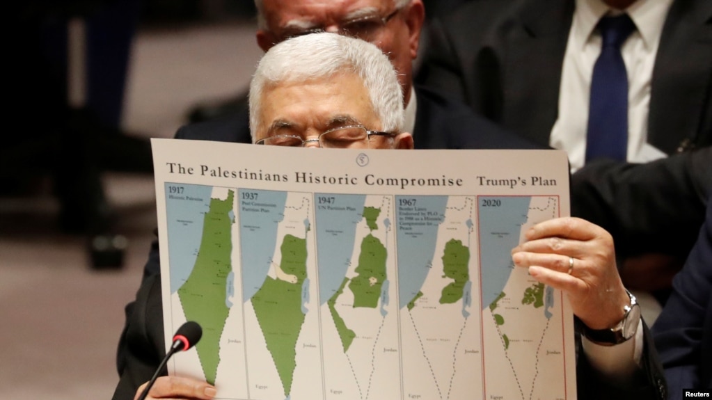 Palestinian President Mahmoud Abbas holds a document while speaking during a Security Council meeting at the United Nations in New York, Feb. 11, 2020.