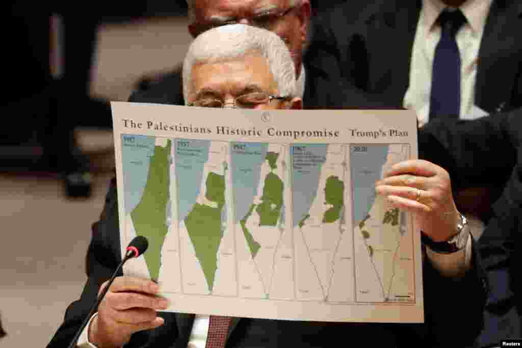 Palestinian President Mahmoud Abbas holds a document while speaking during a Security Council meeting at the United Nations in New York.