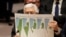 Palestinian President Mahmoud Abbas holds a document while speaking during a Security Council meeting at the United Nations in New York, Feb. 11, 2020. 