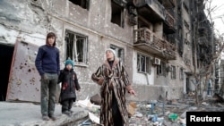 Local residents gather in a courtyard in Mariupol