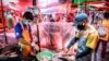 Vendors clean fish at Khlong Toei Market, the biggest fresh market in Bangkok, Thailand.