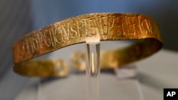 This Monday, June 13, 2016 photo shows a bronze slave collar of the 5th century displayed at "Made in Roma" exhibition at the Trajan's Markets site in Rome. 