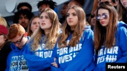FILE: Students listen to a shooting survivor from Parkland, Fl. high school shooting during "March for our Lives," Washington, D.C. March 24, 2018