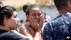 A student cries outside the Raul Brasil State School in Suzano, the greater Sao Paulo area, Brazil, Wednesday, March 13, 2019. The state government of Sao Paulo said two teenagers, entered the school and began shooting at students. (AP Photo/Andre Penner)