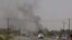 FILE - Smoke rises from a government building in al-Houta, the provincial capital of Yemen's southern Lahej province, March 21, 2015. 