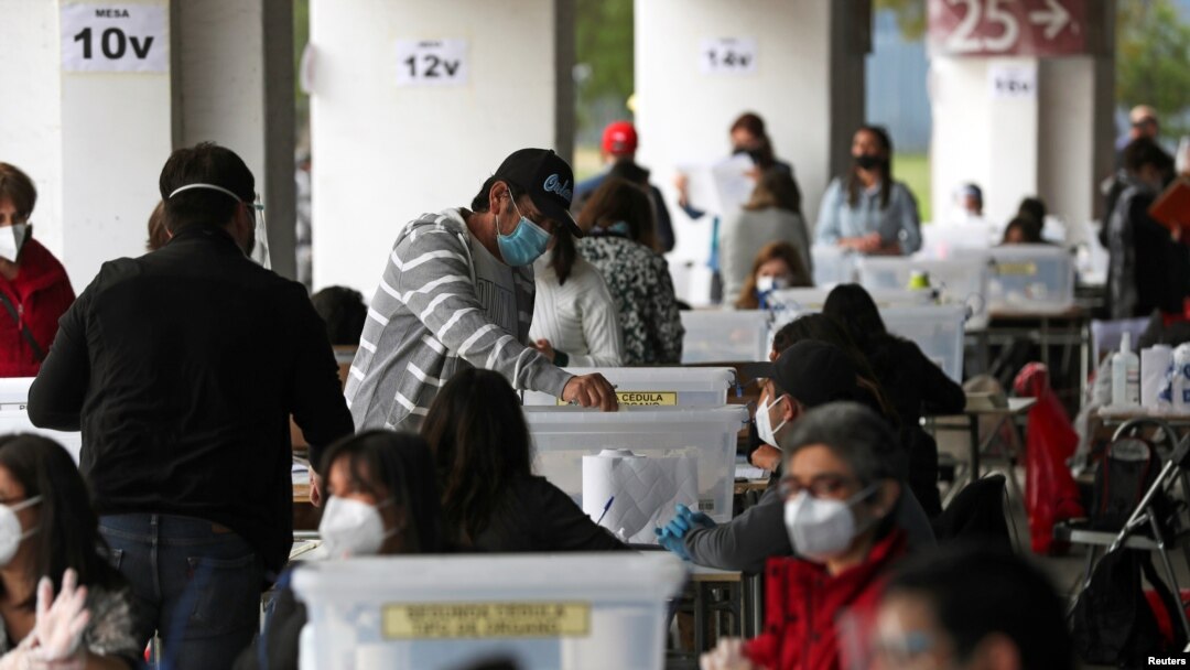 A man casts a ballot during a referendum on a new Chilean constitution in Santiago, Chile, Oct. 25, 2020.