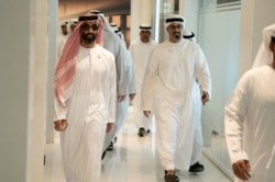 In this Feb. 6, 2019 photo, released by Emirates News Agency, Sheikh Tahnoun bin Zayed Al Nahyan, left, walks to a meeting in Abu Dhabi, UAE.