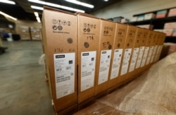 Four pallets of Lenovo Chromebook laptops sit in a Denver Public Schools warehouse after arriving, Aug. 21, 2020, in Denver.